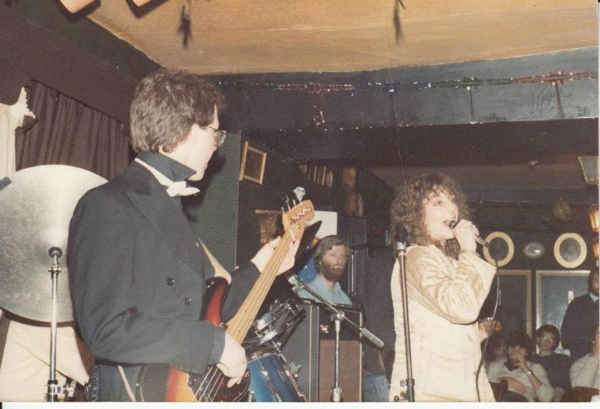 Colour photographic image showing Teresa Pole-Baker Gouveia (Economics) and her student band, Tiger, Tiger, performing at The Bell Inn, Bath, 1982.