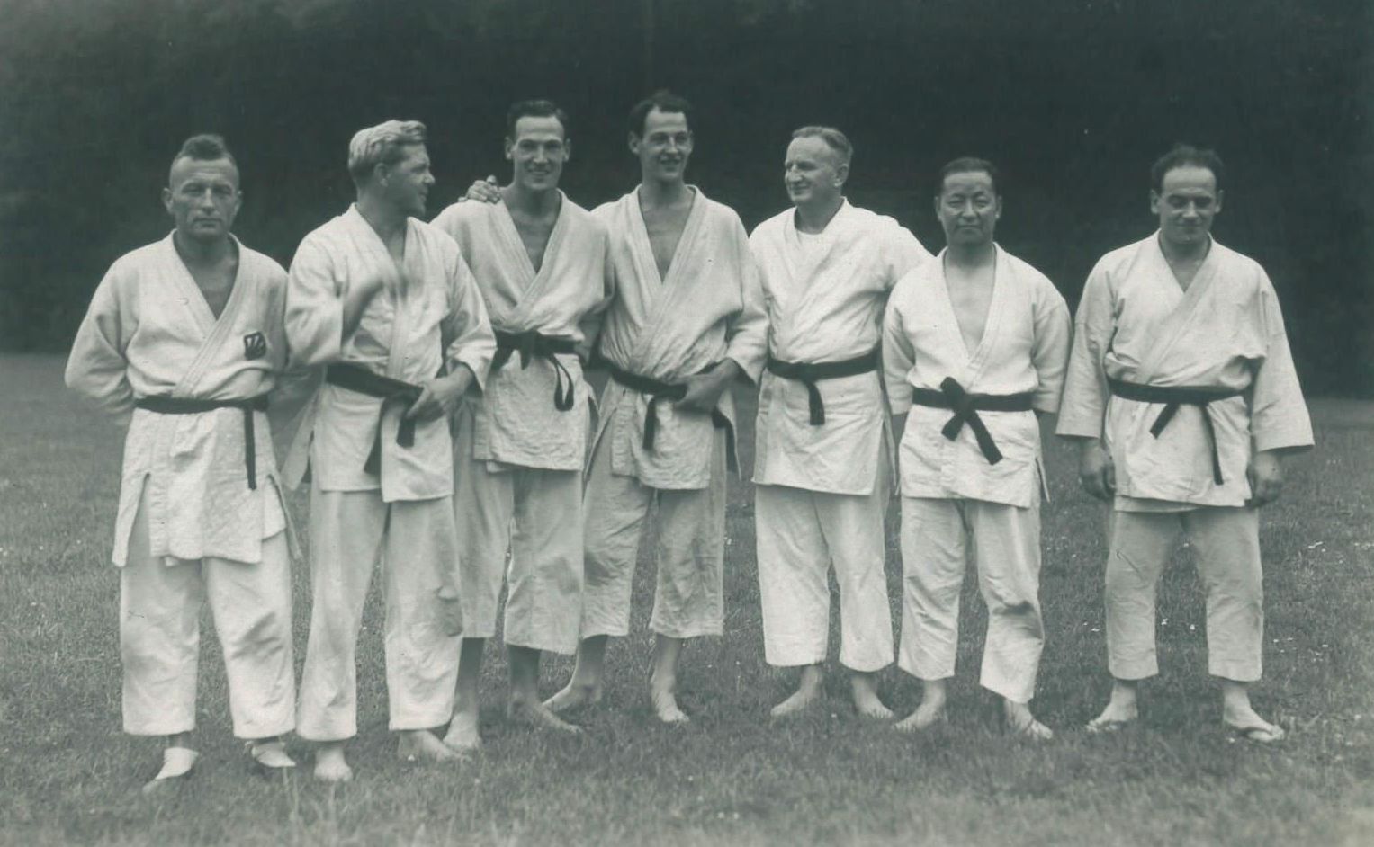 Black and white photograph showing from left to right Otto Schmelzeisen, Max Hoppe, Norman Hyde, Harold Hyde, Alfred Rhode, Hanho Rhi and Tibor Vincent at a judo summer school in Frankfurt, Germany, 1939.