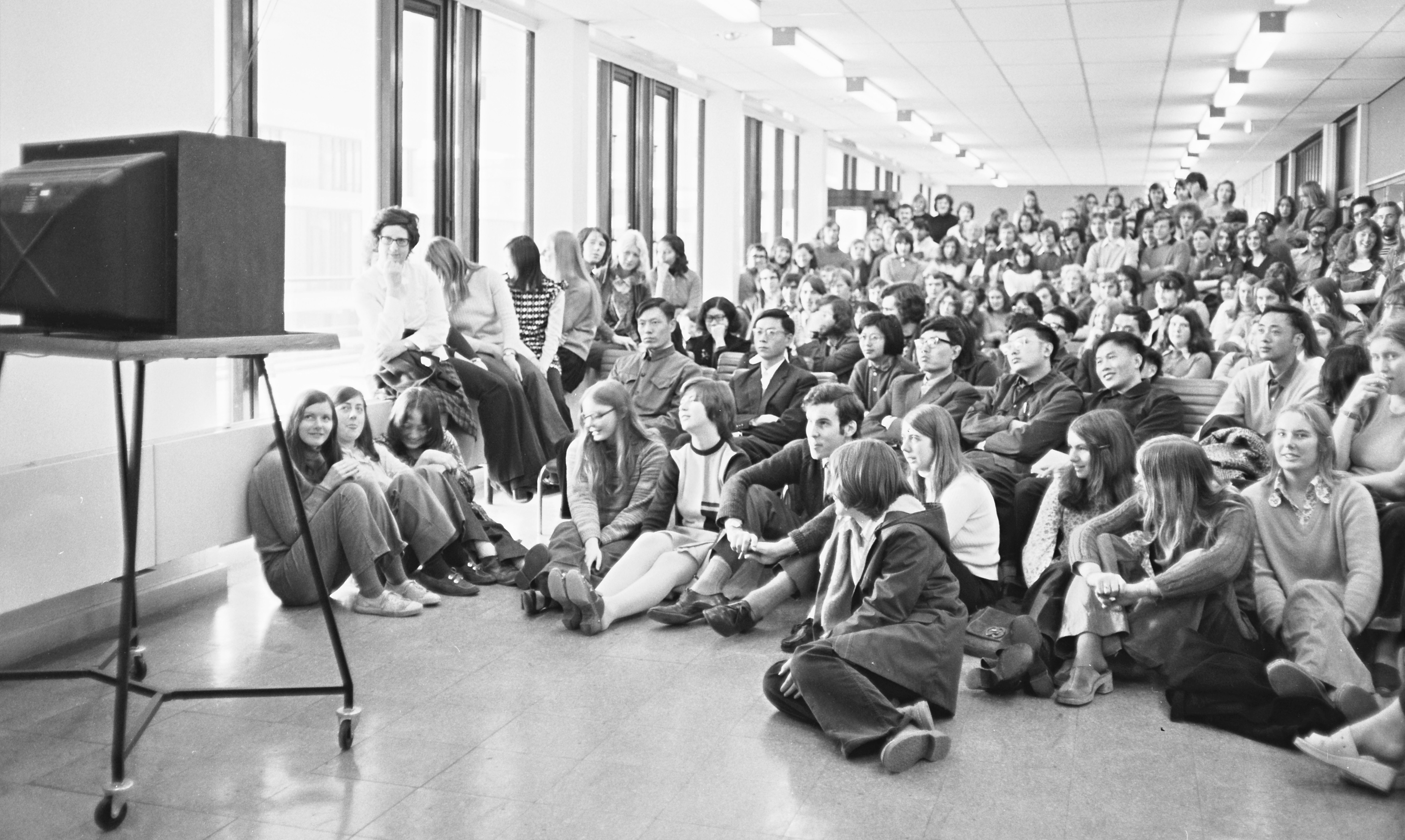 Students, including visitors from China, watching the wedding of Princess Anne on a television in the foyer of the University Library, 14 November 1973